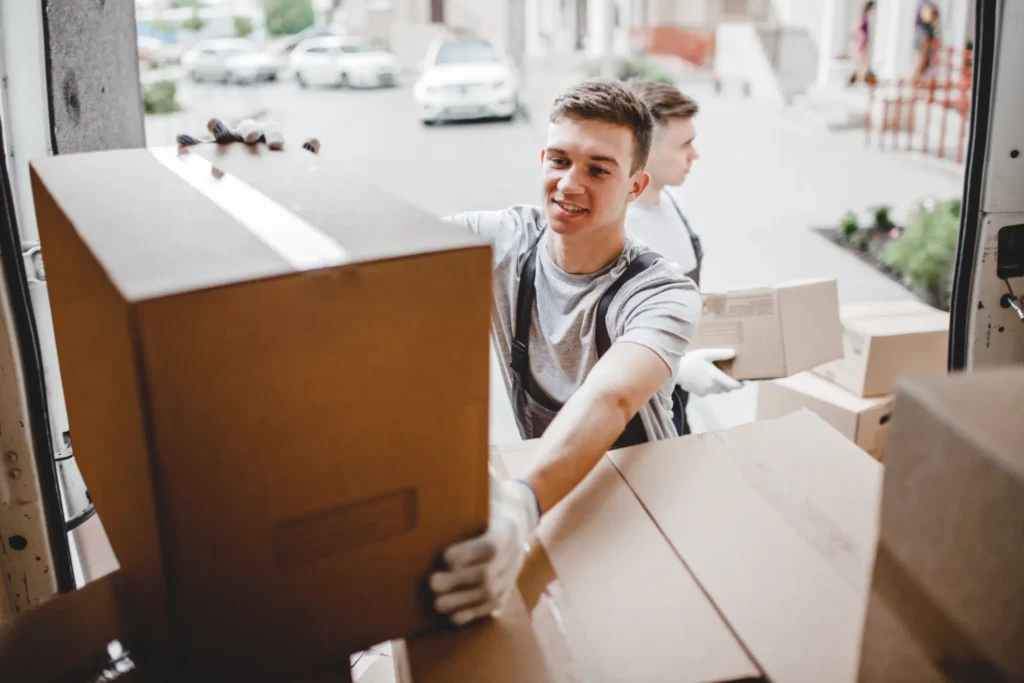 male mover loading boxes into moving truck
